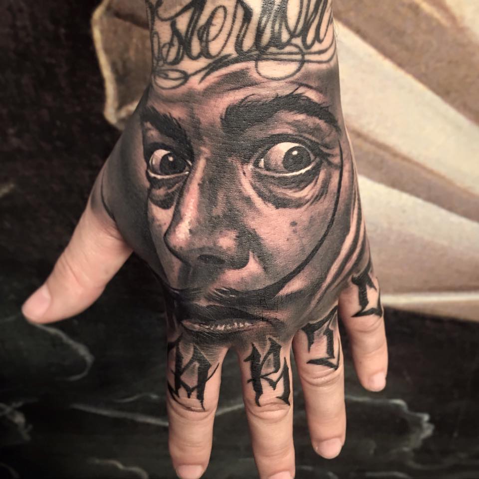 Black Ink Man Face Tattoo On Left Hand