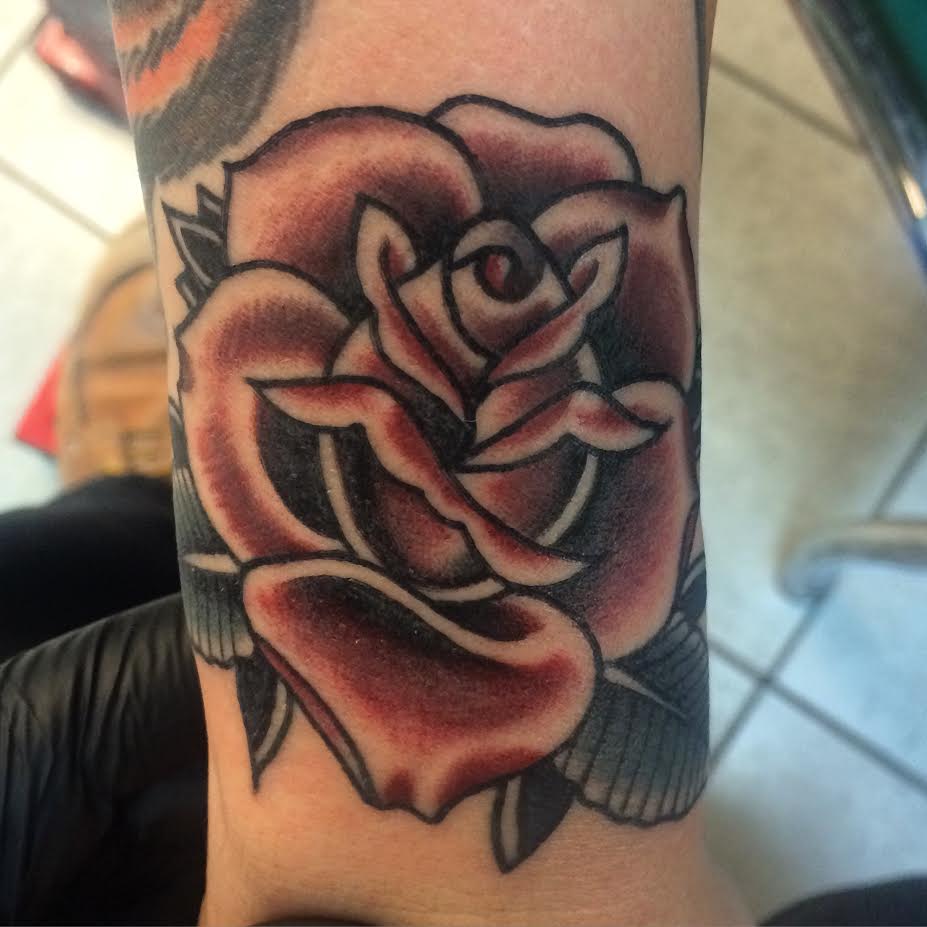 Black Ink Rose Tattoo On Wrist By Justin Brooks