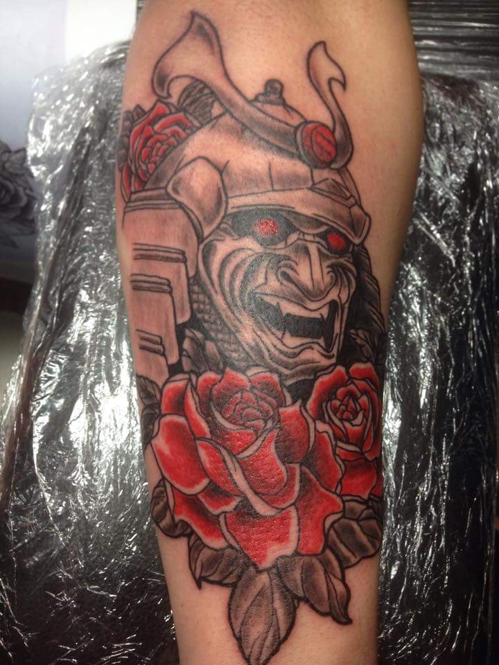 Black Ink Samurai Head With Roses Tattoo Design For Forearm