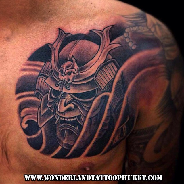 Black Ink Samurai Mask Tattoo On Left Chest