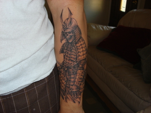 Black Ink Samurai Warrior Tattoo On Left Forearm