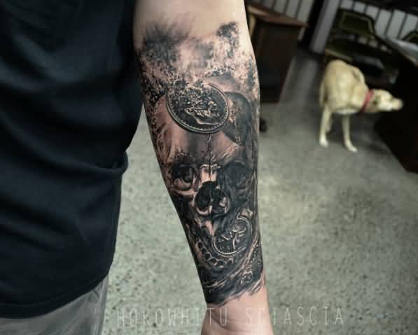 Black Ink Skull Tattoo On Man Left Forearm
