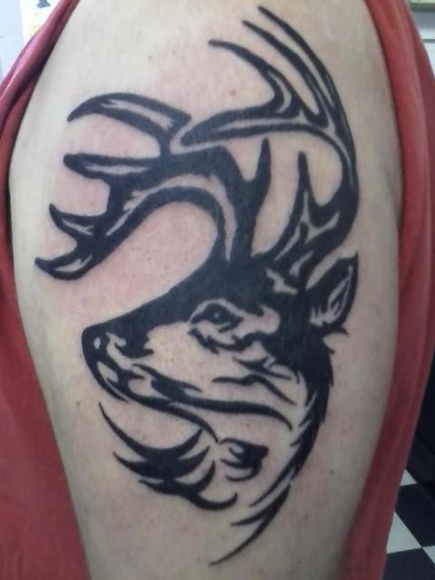 Black Ink Tribal Deer Tattoo On Left Bicep