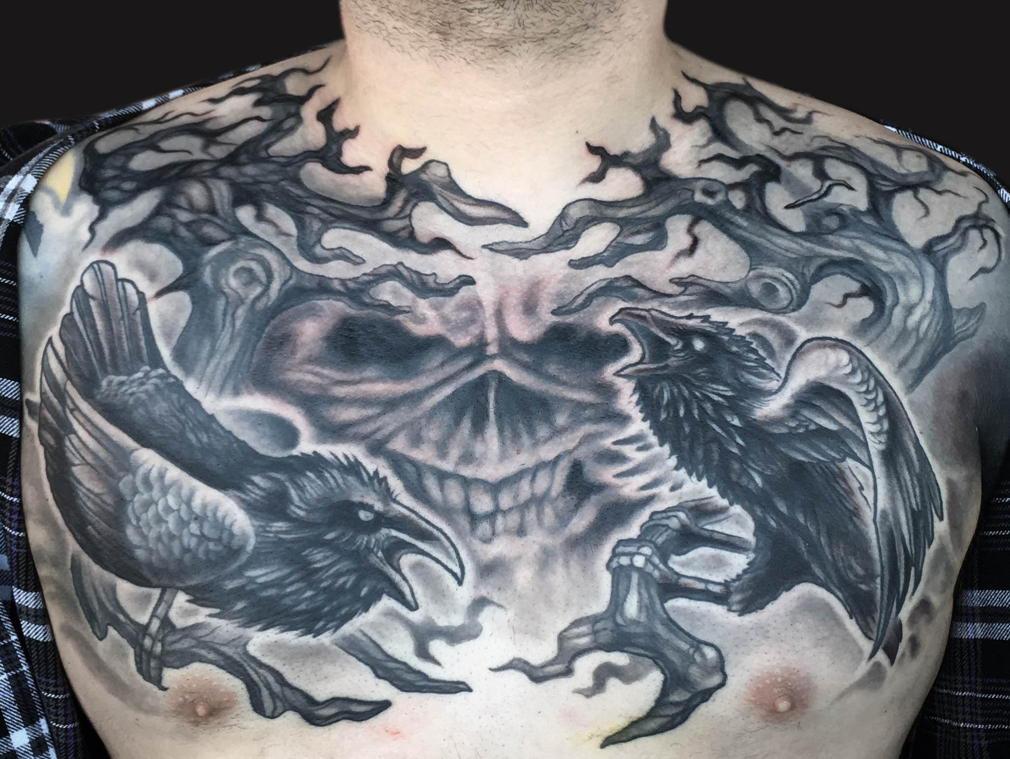 Black Ink Two Ravens With Skull Tattoo On Man Chest By Spencer Caligiuri