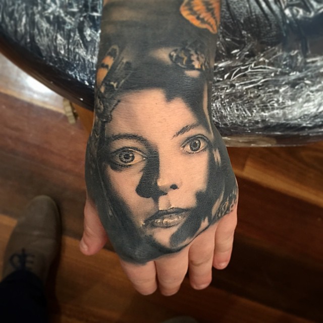 Classic Black And Grey Girl Face Tattoo On Left Hand