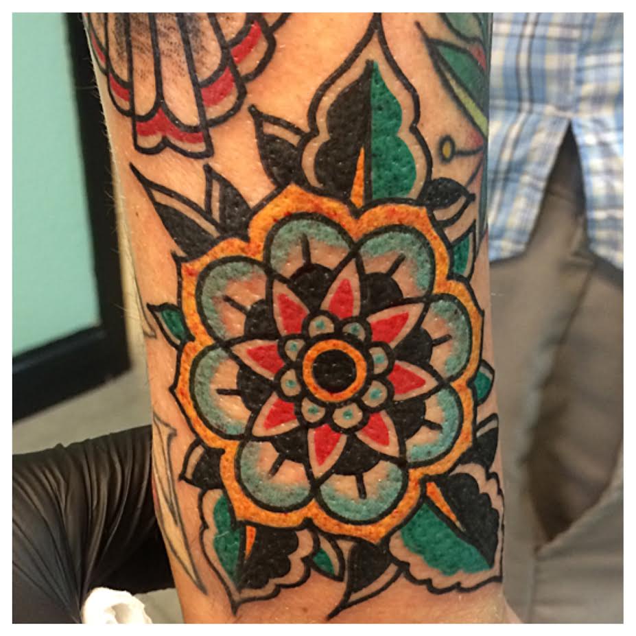 Colorful Traditional Flower Tattoo On Half Sleeve