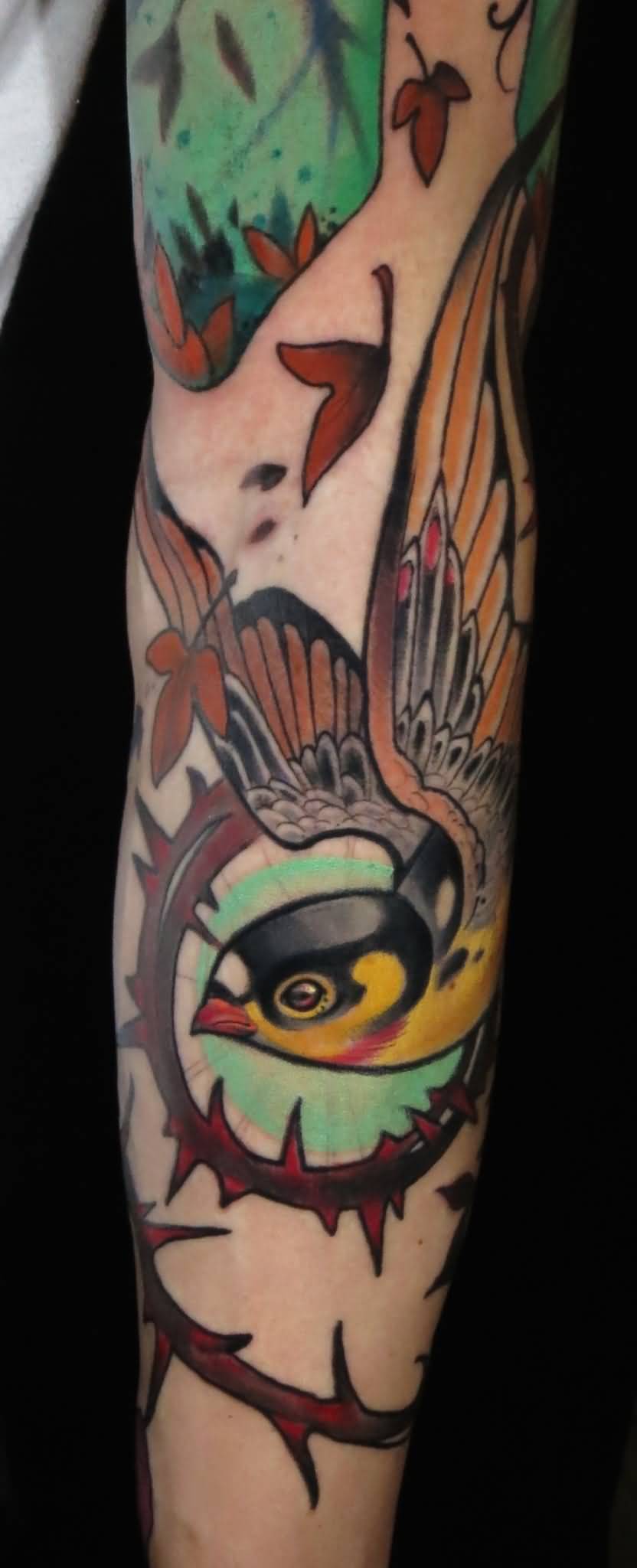 Colorful Traditional Flying Bird Tattoo On Forearm By Curtis Burgess
