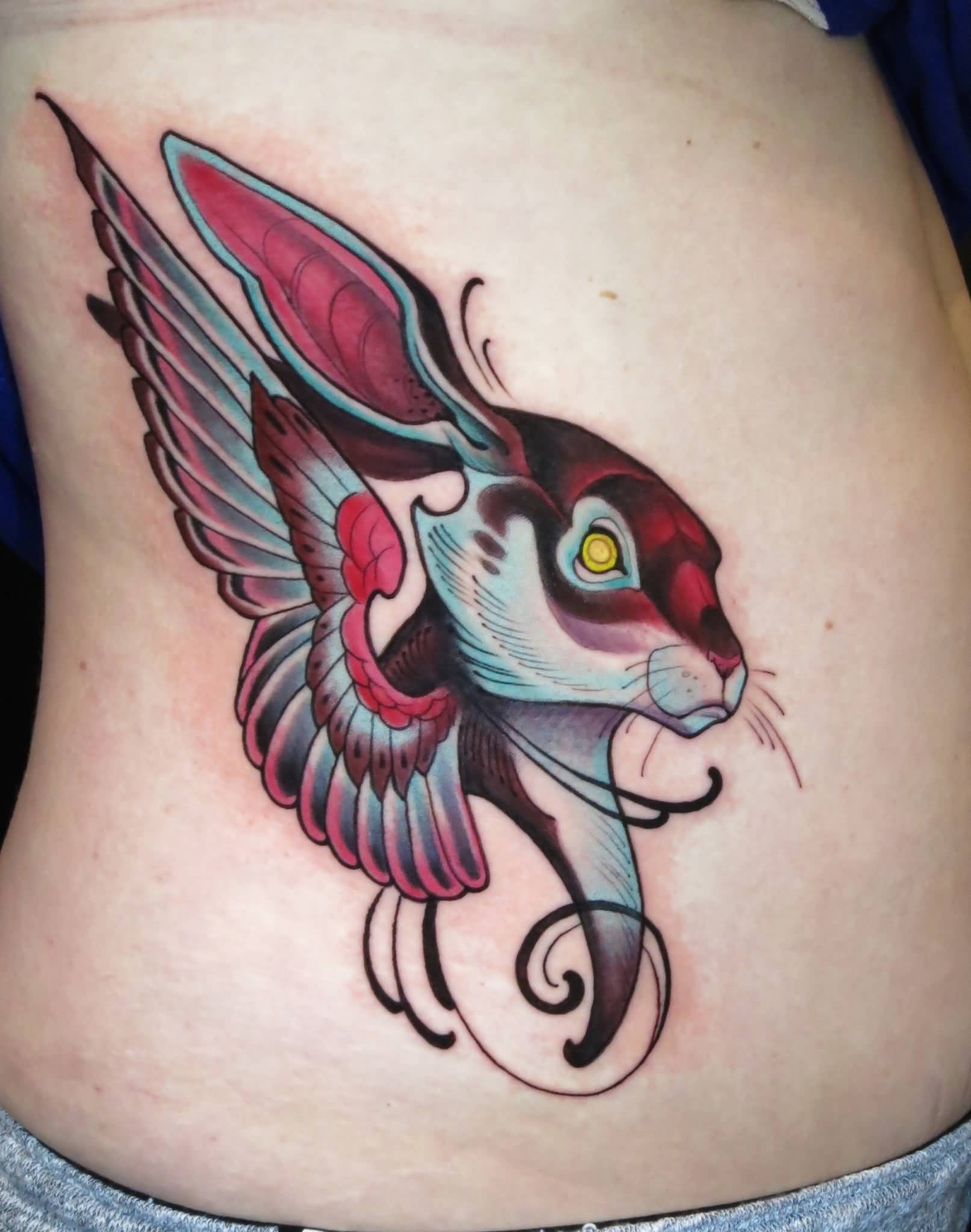 Cool Traditional Rabbit With Wing Tattoo On Man Right Side Rib By Curtis Burgess