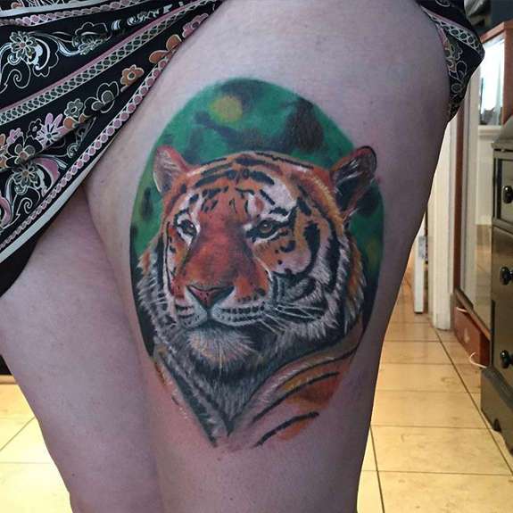 Cute Tiger Face Tattoo On Left Thigh