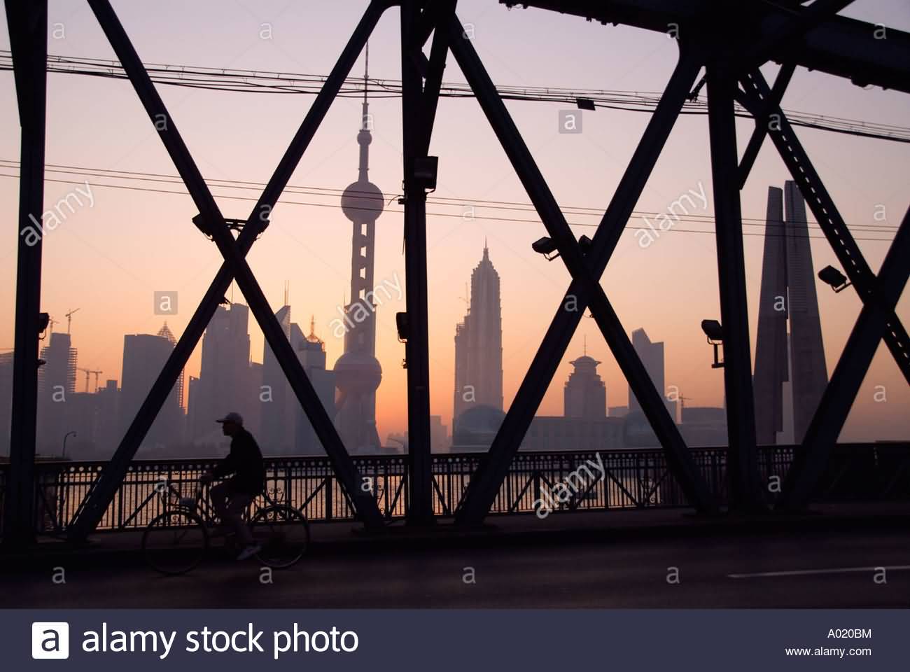 Cyclist Crossing Waibaidu Bridge Over Suzhou River With Pudong Skyline At Dawn