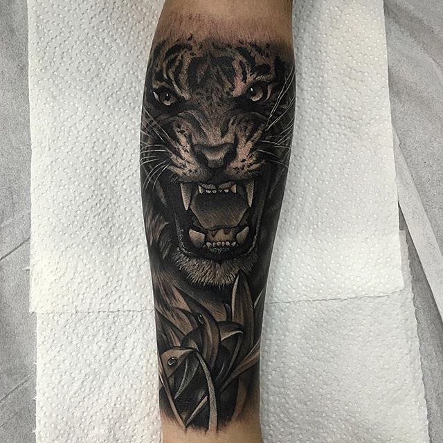 Dark Ink Angry Tiger Face Tattoo On Forearm
