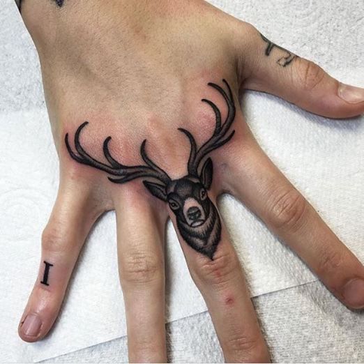 Deer Head Tattoo On Middle Finger
