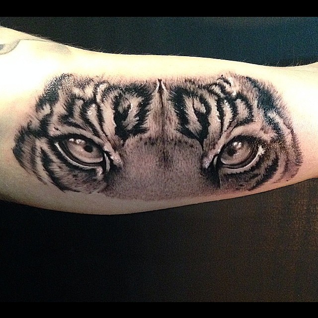 Grey And Black Tiger Eyes Tattoo On Bicep