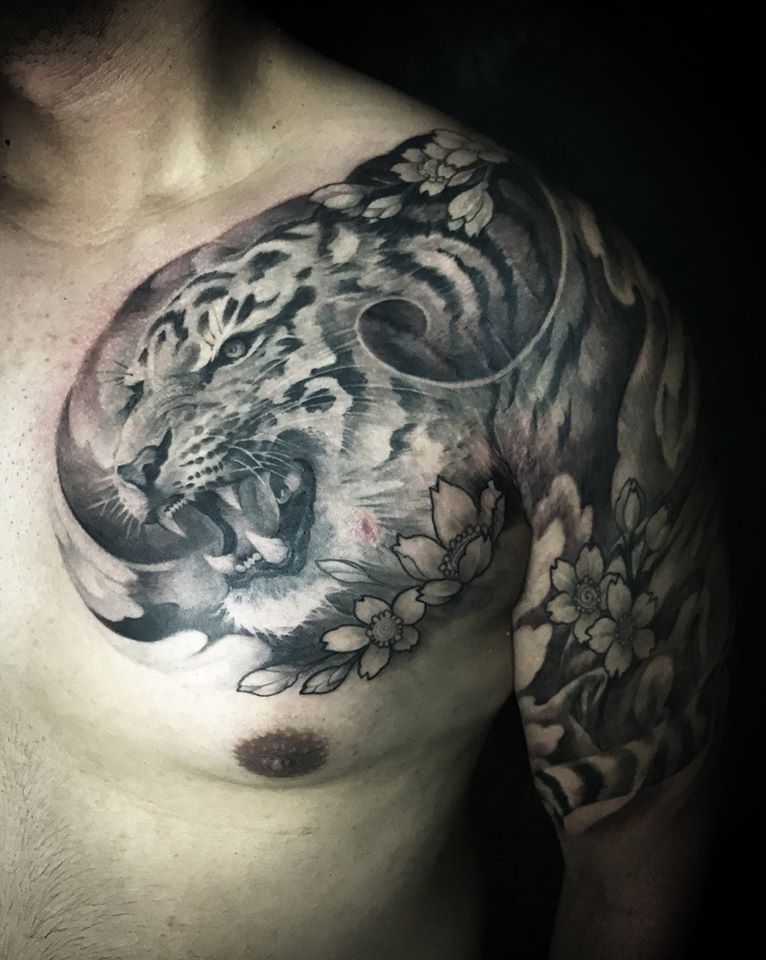 Grey Flowers And Japanese Tiger Tattoo On Chest And Half Sleeve