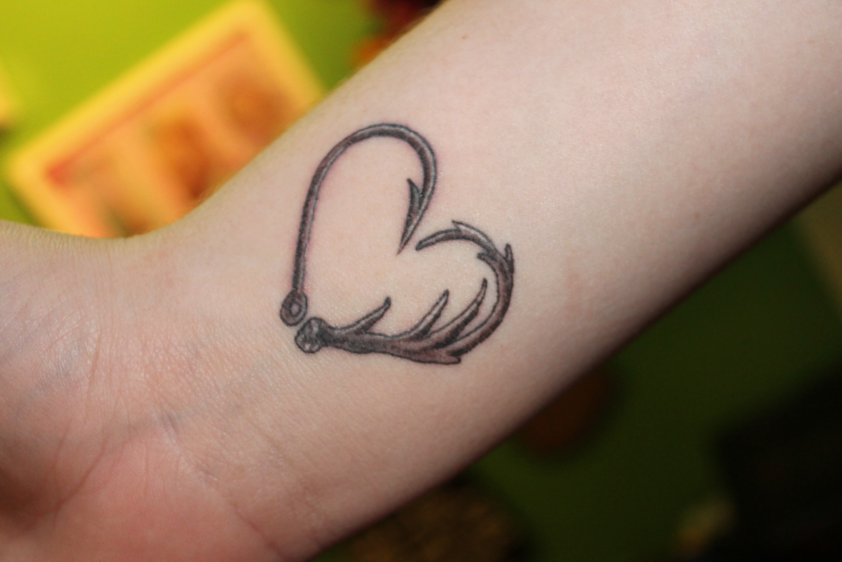 Grey Hook And Deer Antler Tattoo On Wrist