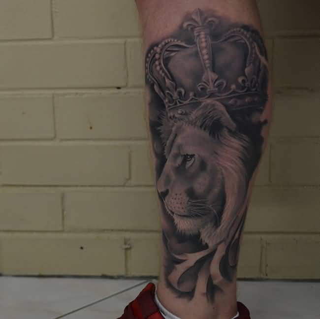 Grey Ink Crown On Lion Head Tattoo On Left Leg