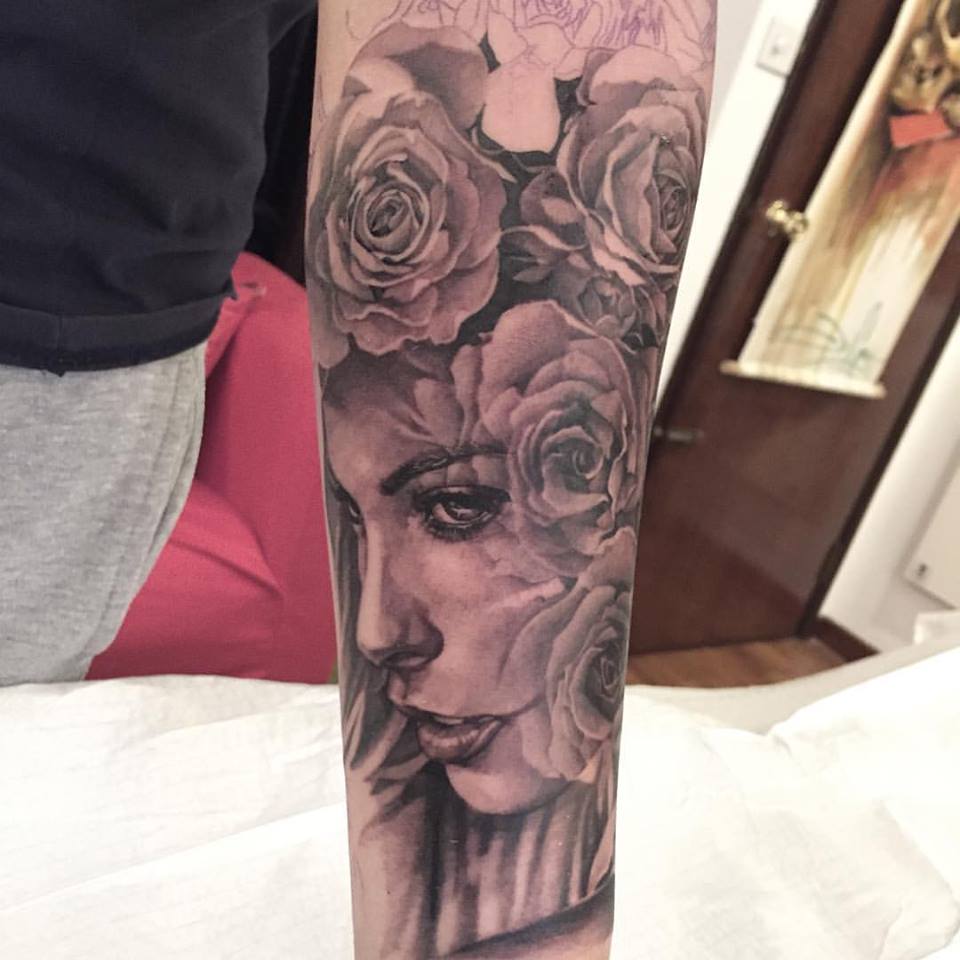 Grey Ink Girl Face With Roses Tattoo On Forearm