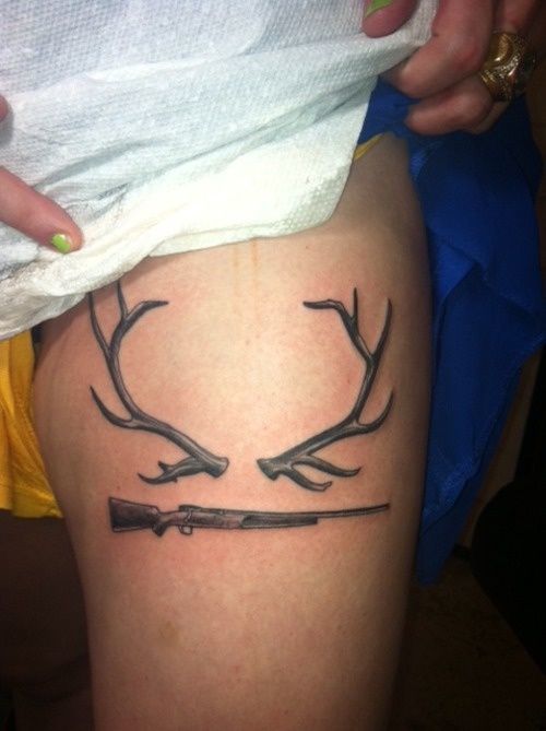Grey Ink Gun And Deer Antler Tattoo On Side Thigh