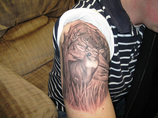 Grey Ink Hunting Deer Tattoo On Shoulder