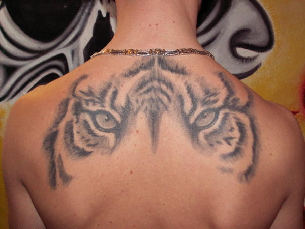 Grey Ink Tiger Eyes Tattoo On Upper Back