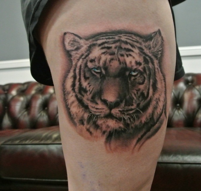Grey Ink Tiger Head Tattoo On Thigh