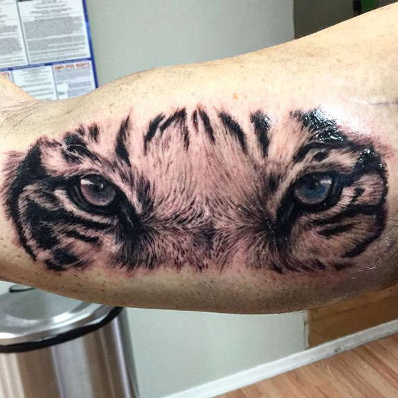 Inner Bicep Tiger Eyes Tattoo Idea