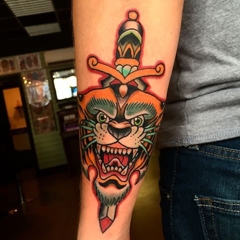 Left Arm Color Ink Dagger In Tiger Head Tattoo