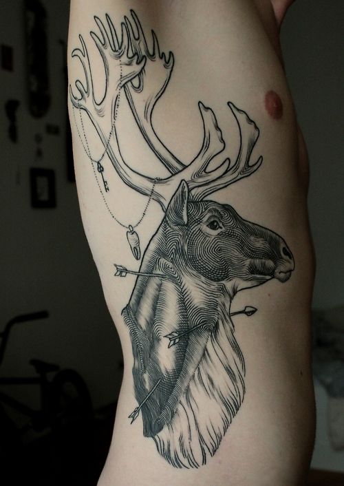 Man Showing His Deer Head Tattoo On Side Rib