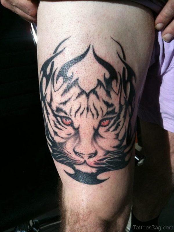 Red Eyes Tribal Tiger Tattoo On Thigh by Tattoosbag