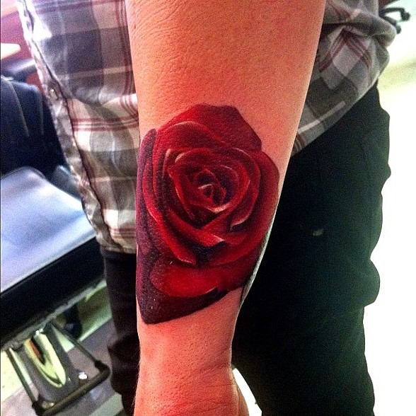 Red Ink Rose Tattoo On Left Arm