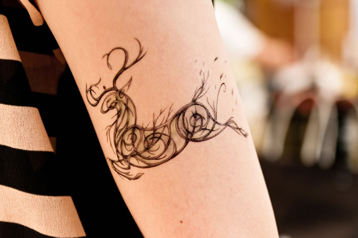 Swirl Deer Tattoo On Bicep For Women