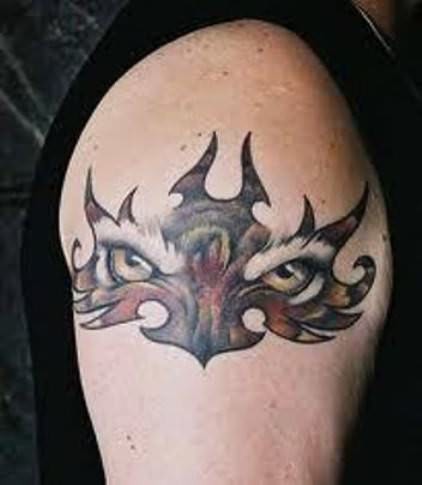 Tiger Eyes In Tribal Tattoo On Right Shoulder