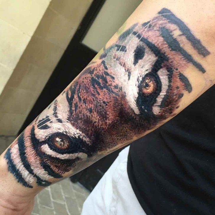 Tiger Eyes Tattoo On Left Forearm by Maksims Zotovs