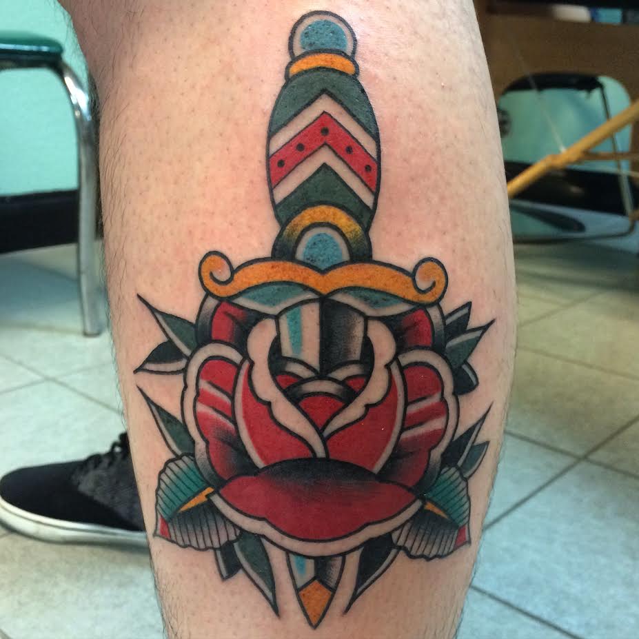 Traditional Dagger In Rose Tattoo On Man Left Leg Calf