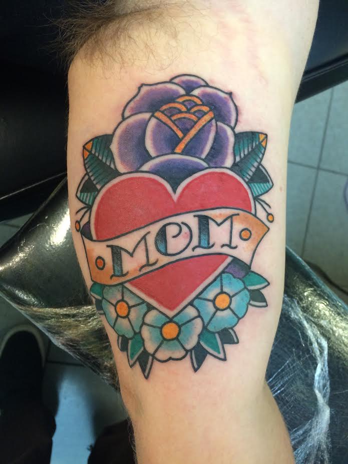 Traditional Heart With Flowers And Mom Banner Tattoo On Left Bicep By Justin Brooks