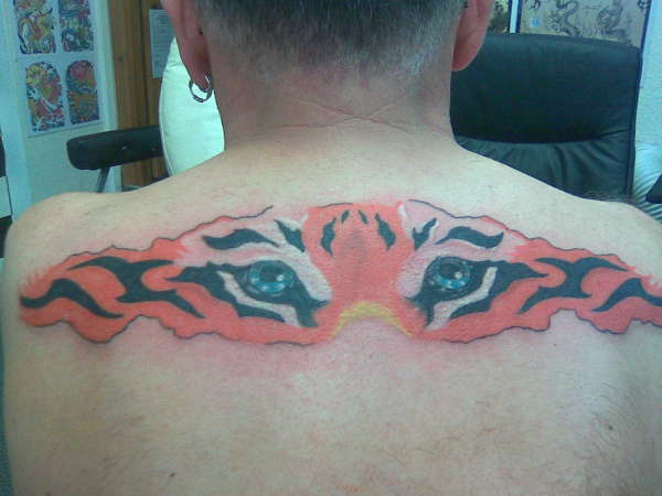Upper Back Tiger Eyes Tattoo For Men
