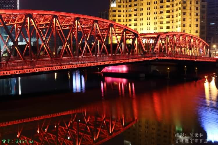 Water Reflection Of Waibaidu Bridge With Red Lights At Night
