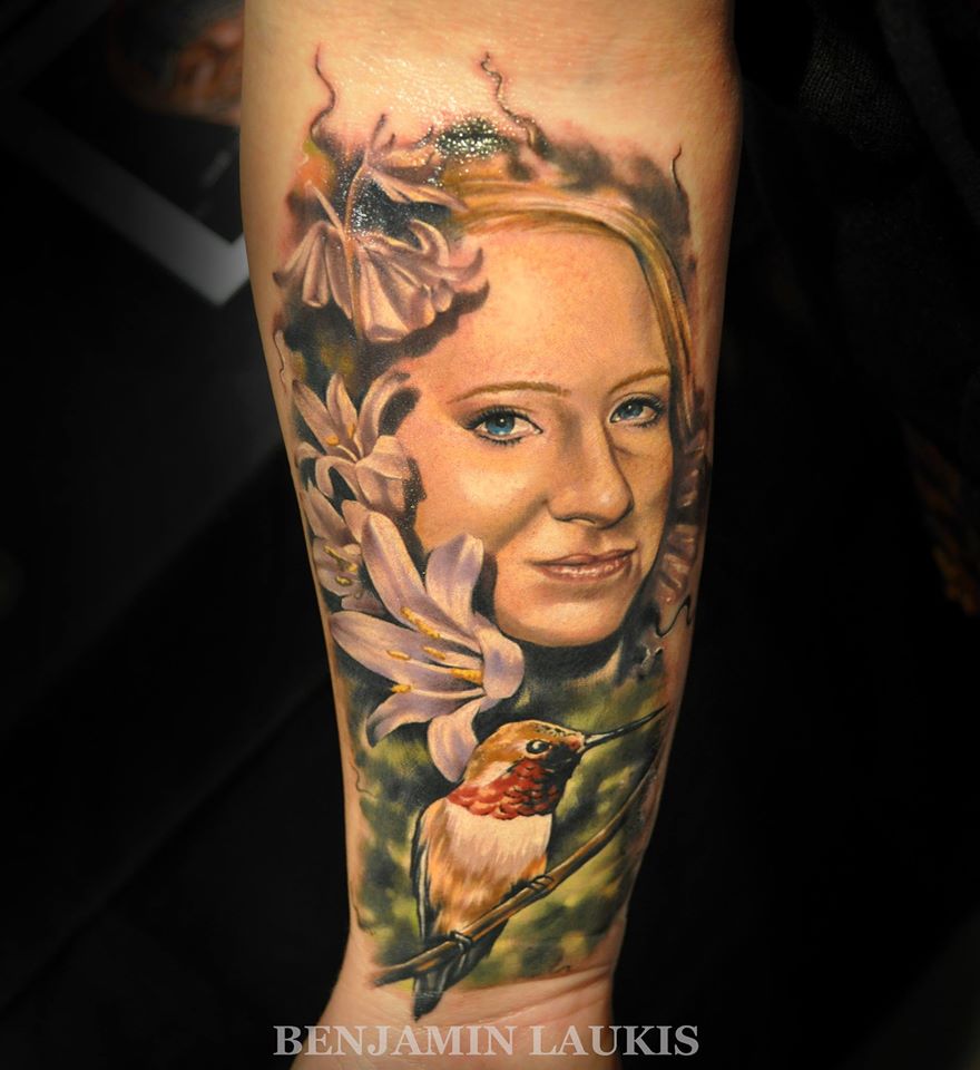 Women Face Portrait With Bird Tattoo On Forearm