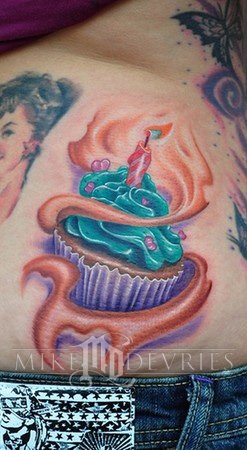 Wonderful 3D Cupcake Tattoo On Side Rib By Mike Devries