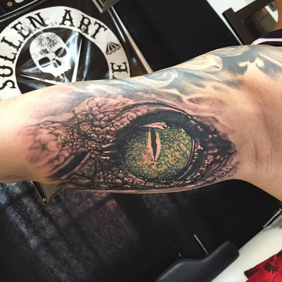 Wonderful Crocodile Eye Tattoo On Right Bicep By Elvin