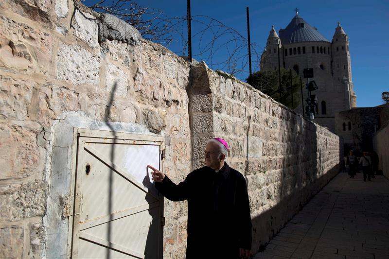 A Monk Points To A Spot Where Graffiti Was Left Near Dormition Abbey