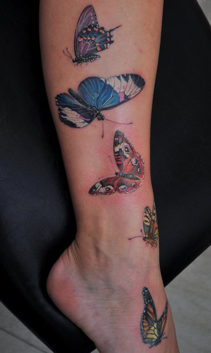 Attractive Flying Butterflies Tattoo On Right Leg
