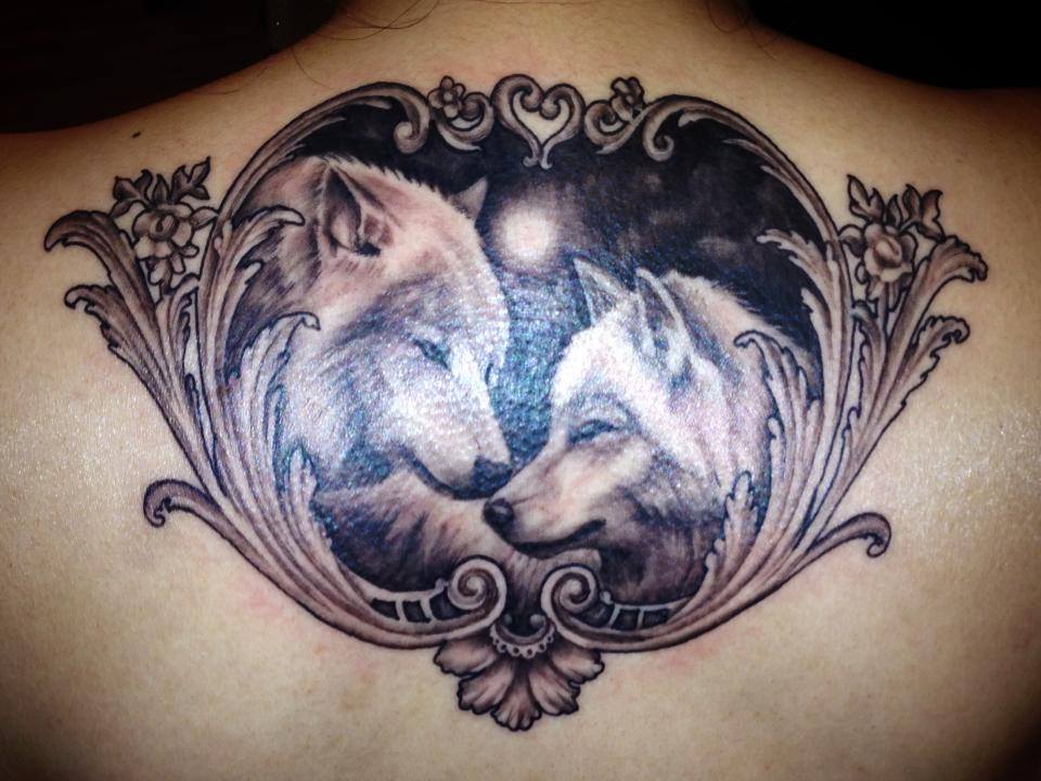Awesome Black And Grey Two Wolfs In Frame Tattoo On Upper Back