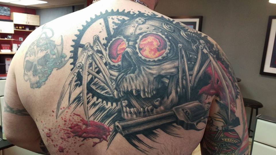Awesome Skull With Spider Legs Tattoo On Man Upper Back By Laura Frego
