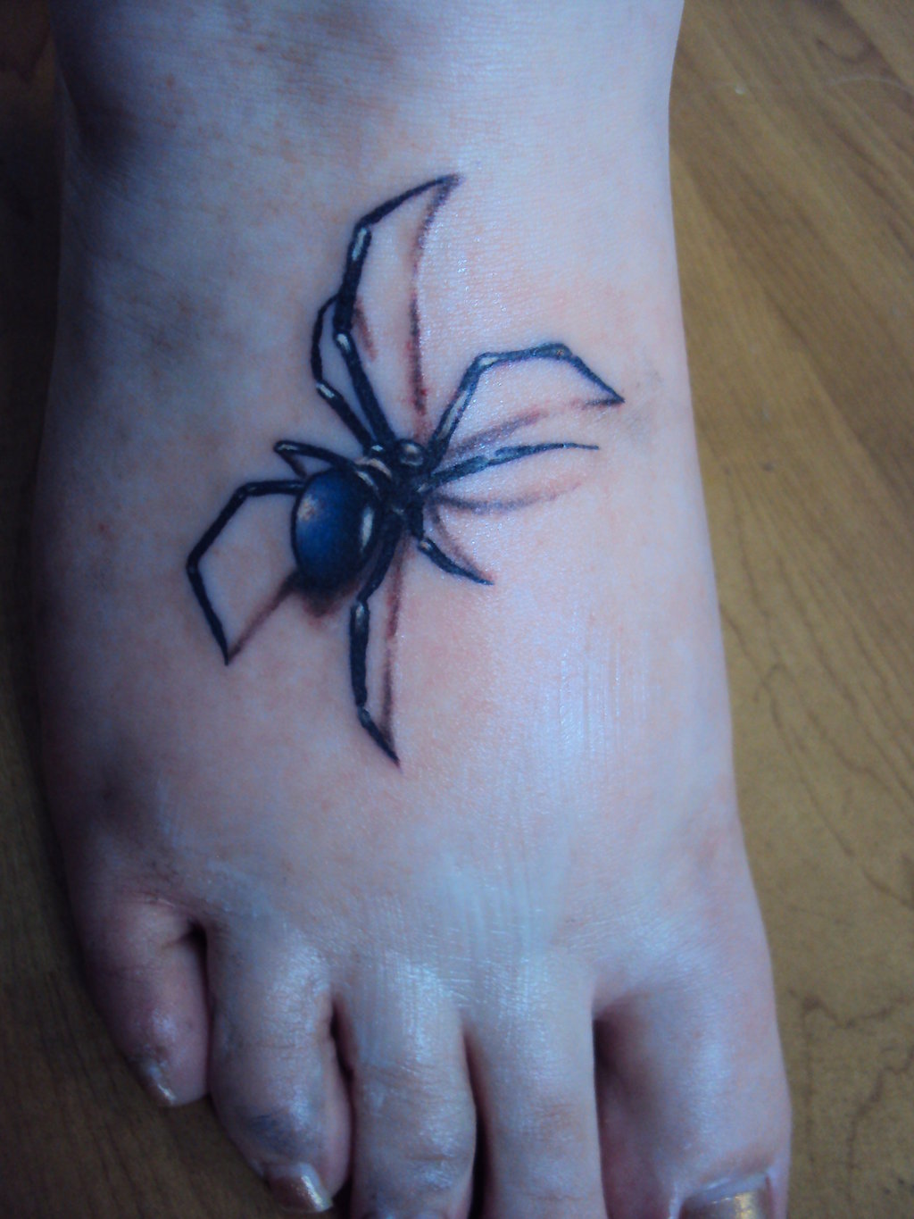 Black And Blue Ink Spider Tattoo On Right Foot