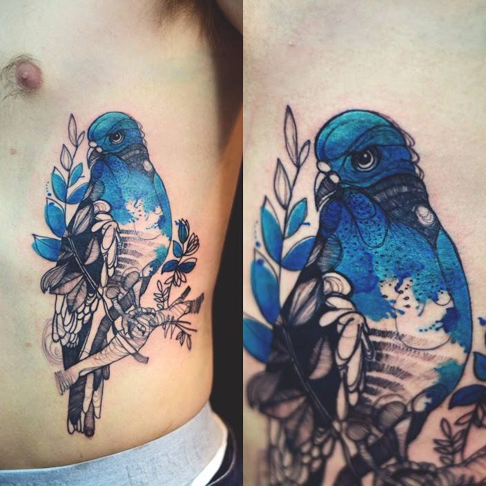 Black And Blue Pigeon Tattoo On Man Left Side Rib