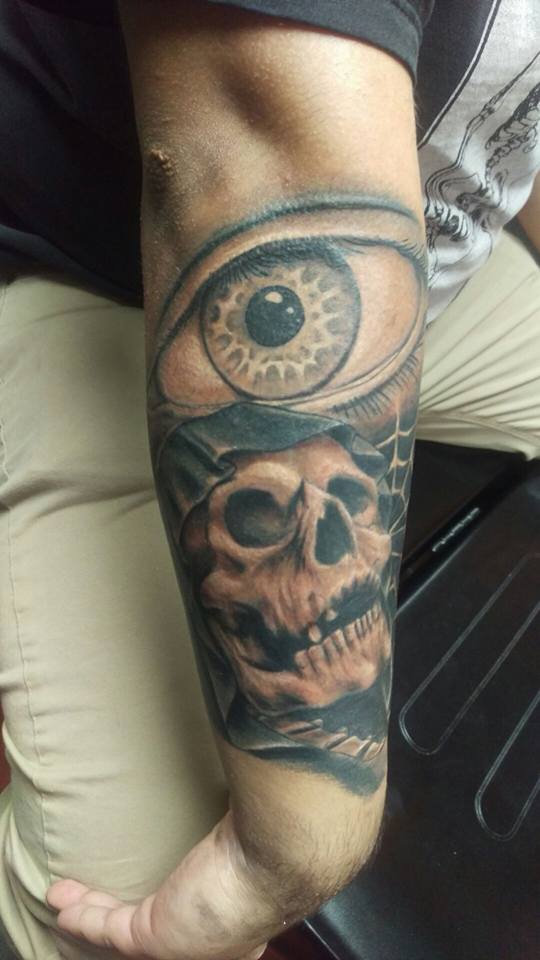 Black And Grey Eye With Skull Tattoo On Right Arm