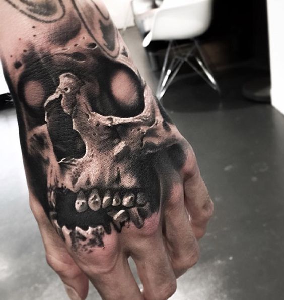 Black And Grey Skull Tattoo On Left Hand