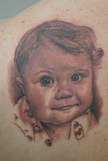Black Ink Baby Face Tattoo Design By Tom Renshaw