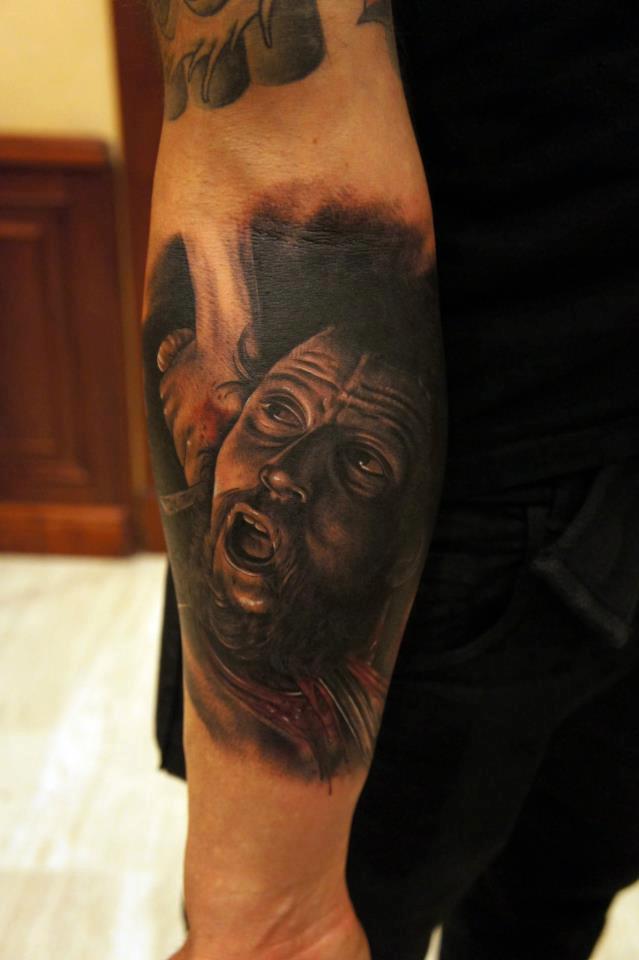 Black Ink Caravaggio Portrait Tattoo On Left Forearm